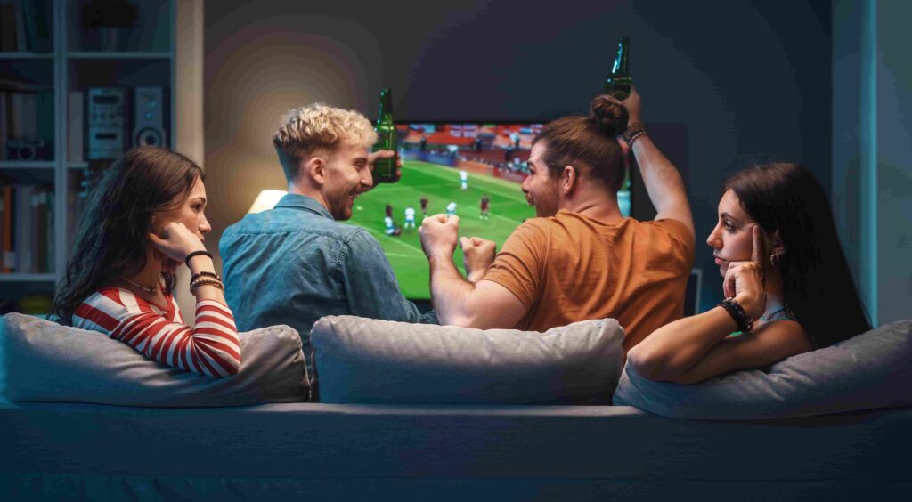 De nummer één IPTV-aanbieder van Nederland in 2025 2 girls talking while men are watching soccer on tv